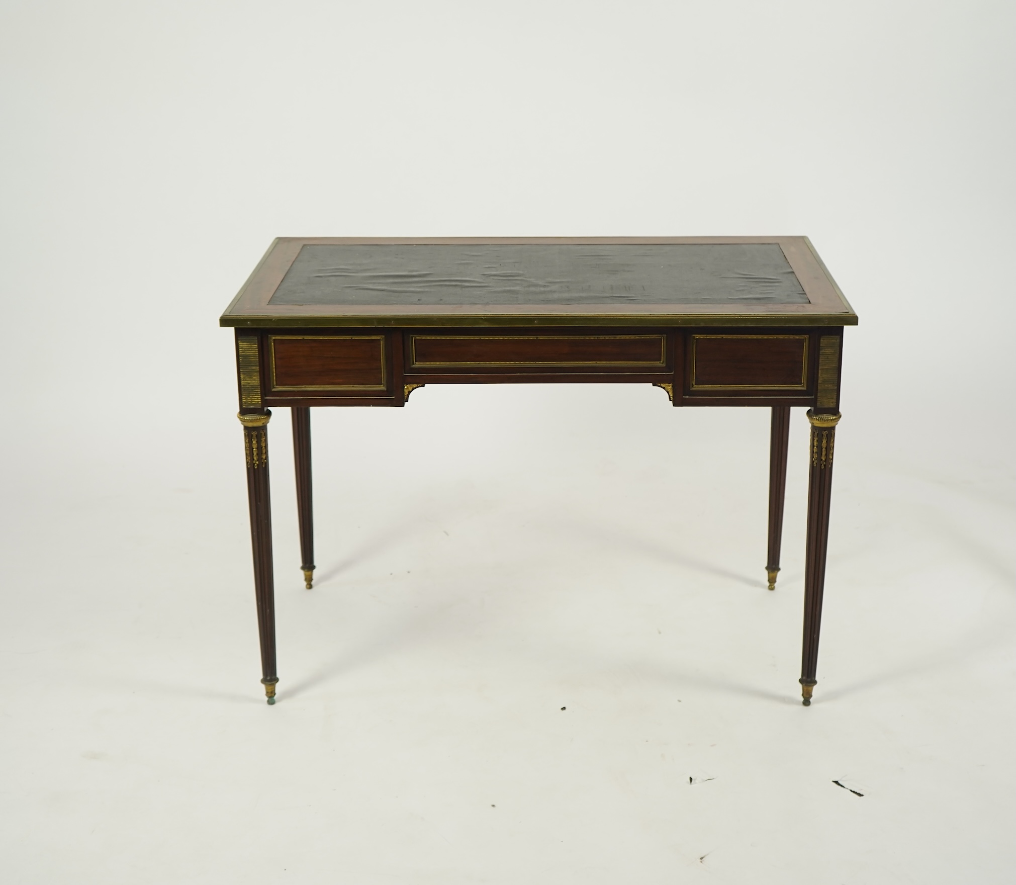 An early 20th century Louis XVI style brass mounted mahogany writing table